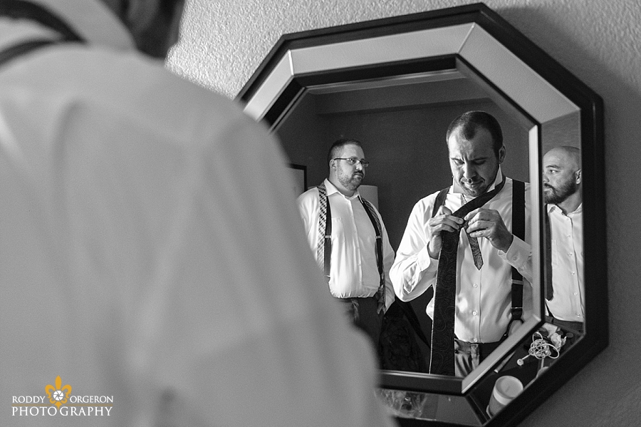 groom looking in mirror getting ready