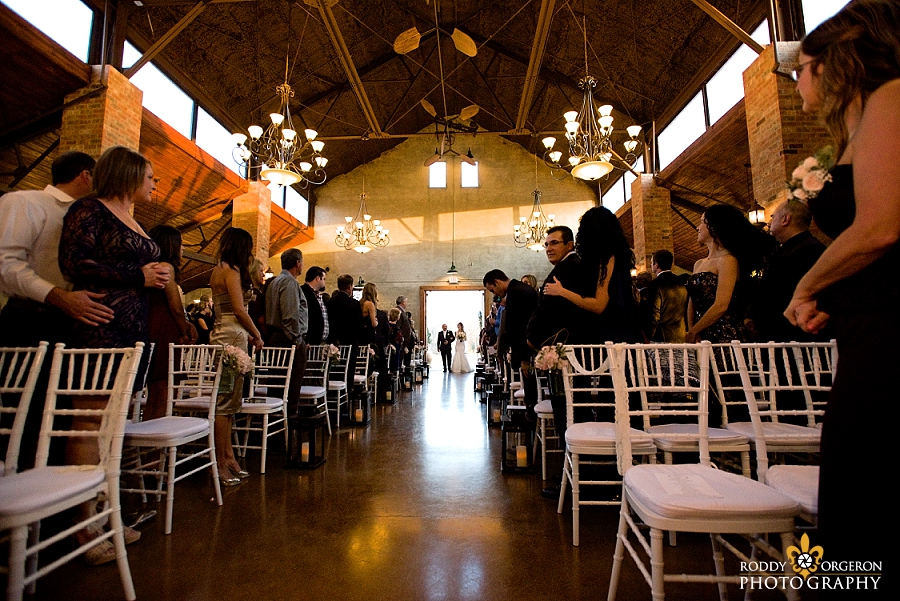 Bride walking into The Olde Dobbin Station in Texas for the ceremony