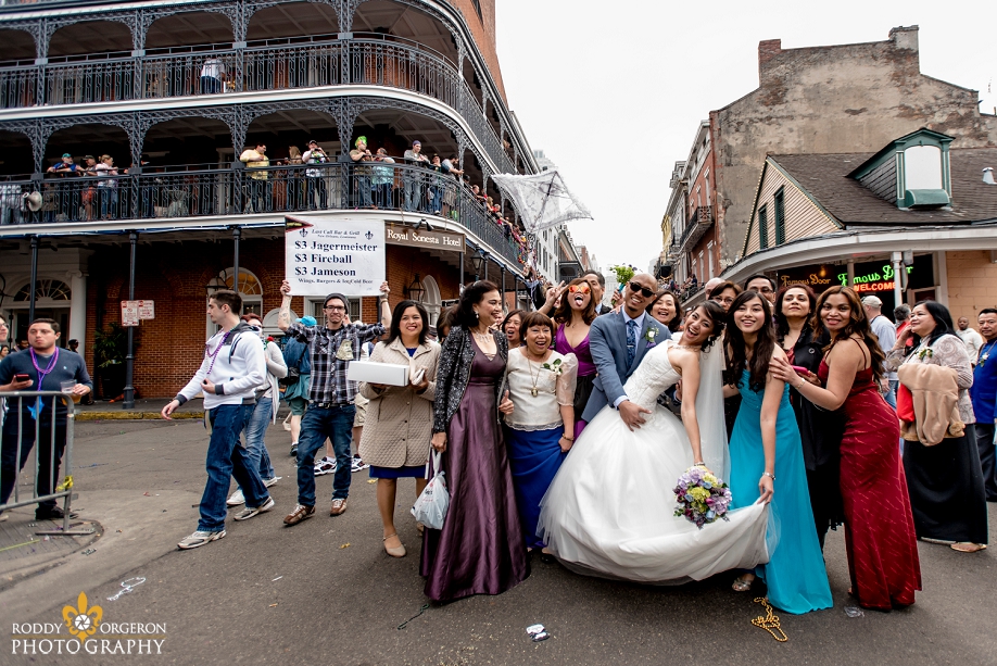 bride and groom posing on Bourbon Street in the French Quarter New Orleans