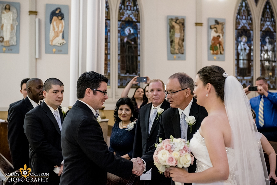 groom sees his bride for the first time and shakes her dads hand