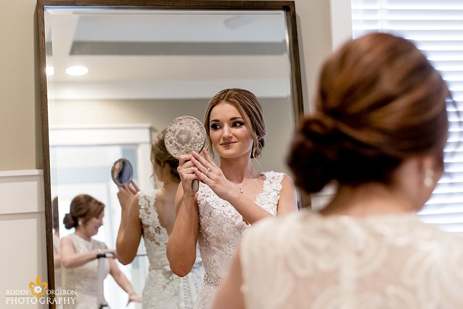 bridal prep with bride looking in the mirror