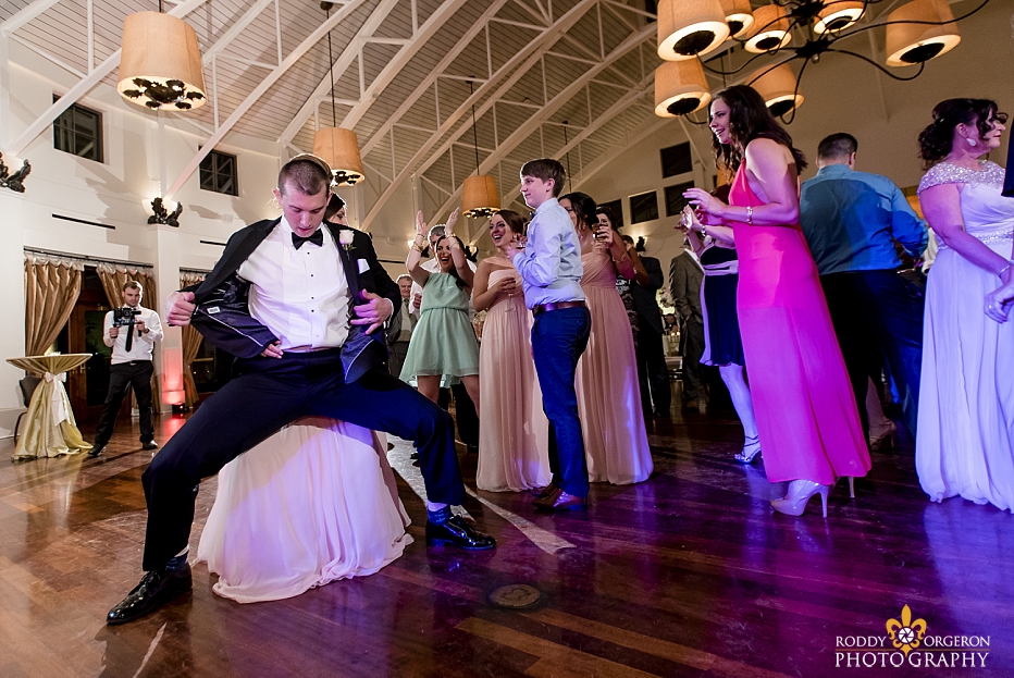  groomsmen dances on the dance floor with the bride at The Audubon Tea Room in New Orleans