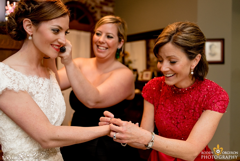 Bride, bridesmaid and mother of the bride preparing for the big day