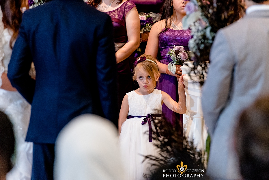 Junior bridesmaid staring at the bride