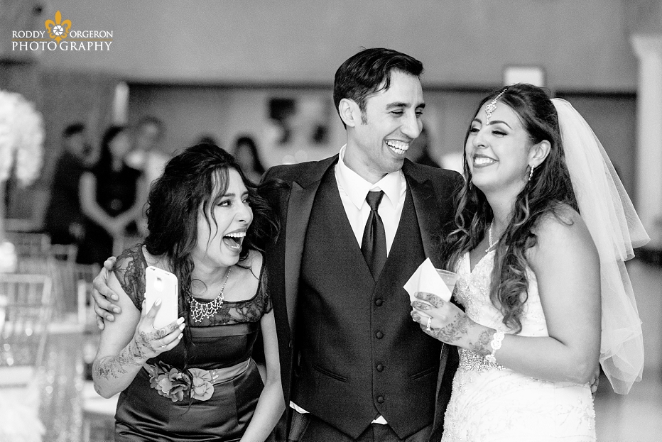 bride, groom and sister laughing