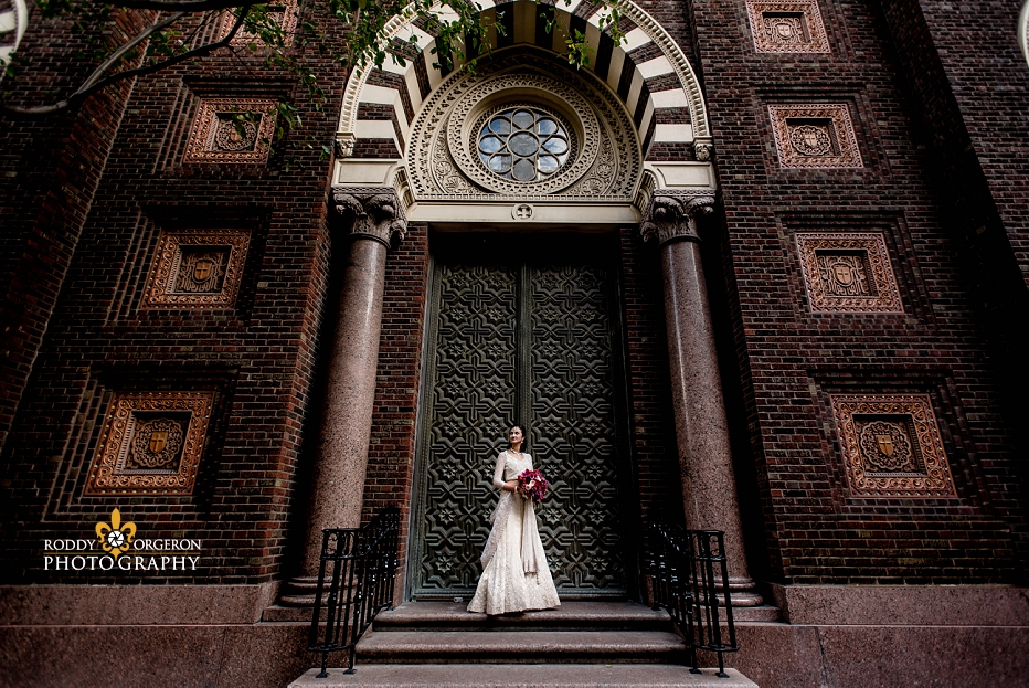 Bride standing in front of a church in her beautiful wedding dress