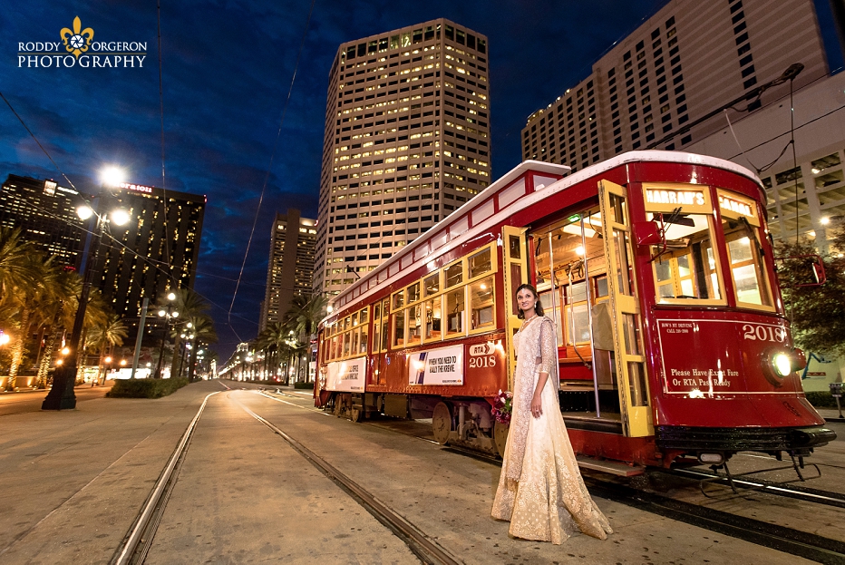 Bride in wedding dress in New Orleans by a street car