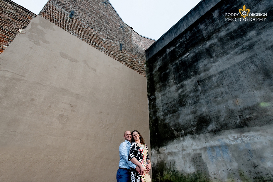 Engagement Session in New Orleans in a parking lot with rustic walls