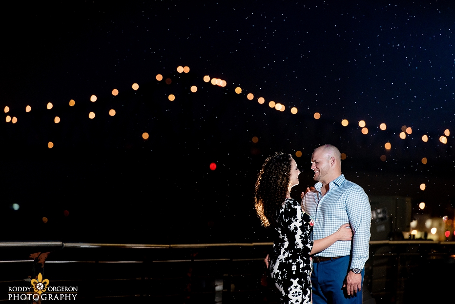 Engagement Session in New Orleans with the Mississippi River bridge in the background and rain drops