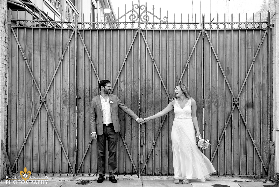 Bride and groom holding hands for an engagement session in the French Quarter of New Orleans