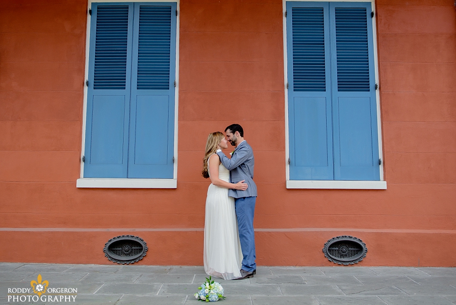 Bride and groom kissing in front of an old New Orleans home in the French Quarter in New Orleans