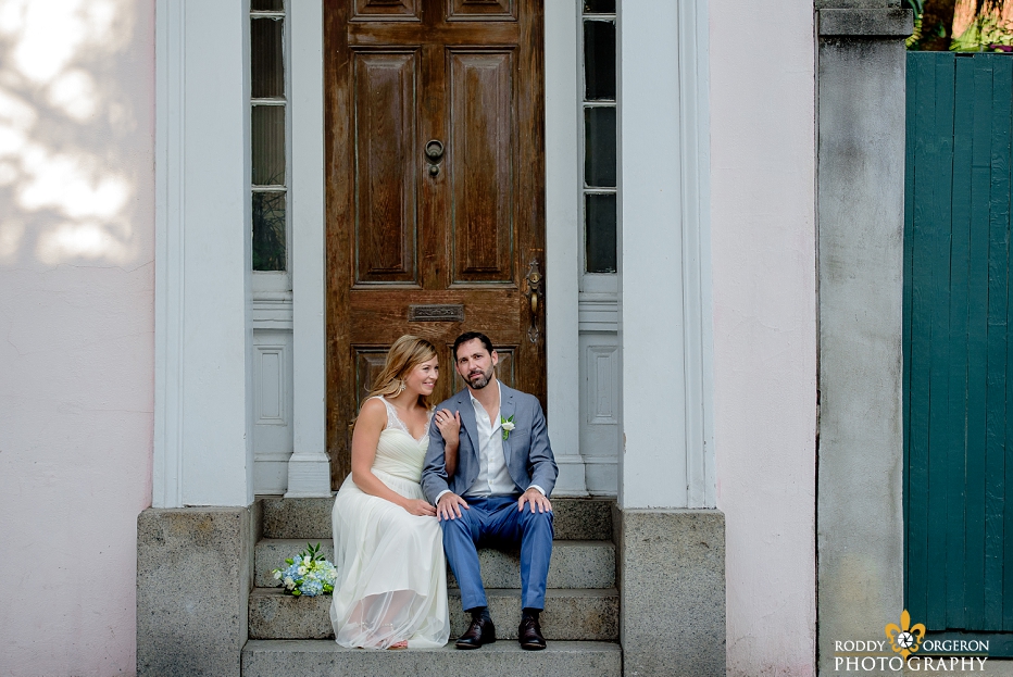 Bride and groom sitting on the steps of an old home in New Orleans