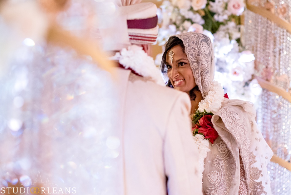 New Orleans Indian wedding ceremony at the Roosevelt hotel - bride smiling at groom