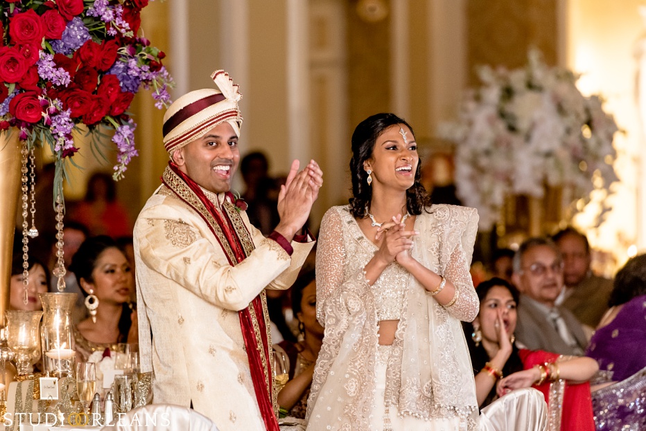 Indian wedding at the Roosevelt hotel - bride and groom clapping for the Bellytwins international