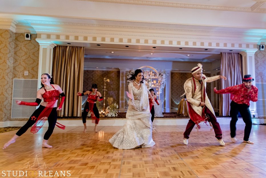 New Orleans Indian wedding reception -The Roosevelt hotel - bride and groom dancing with the Bellytwins international