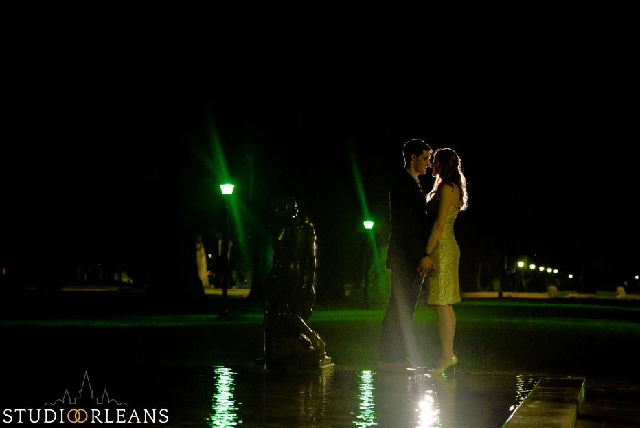 Engaged couple standing in fountain in Audubon Park in New Orleans