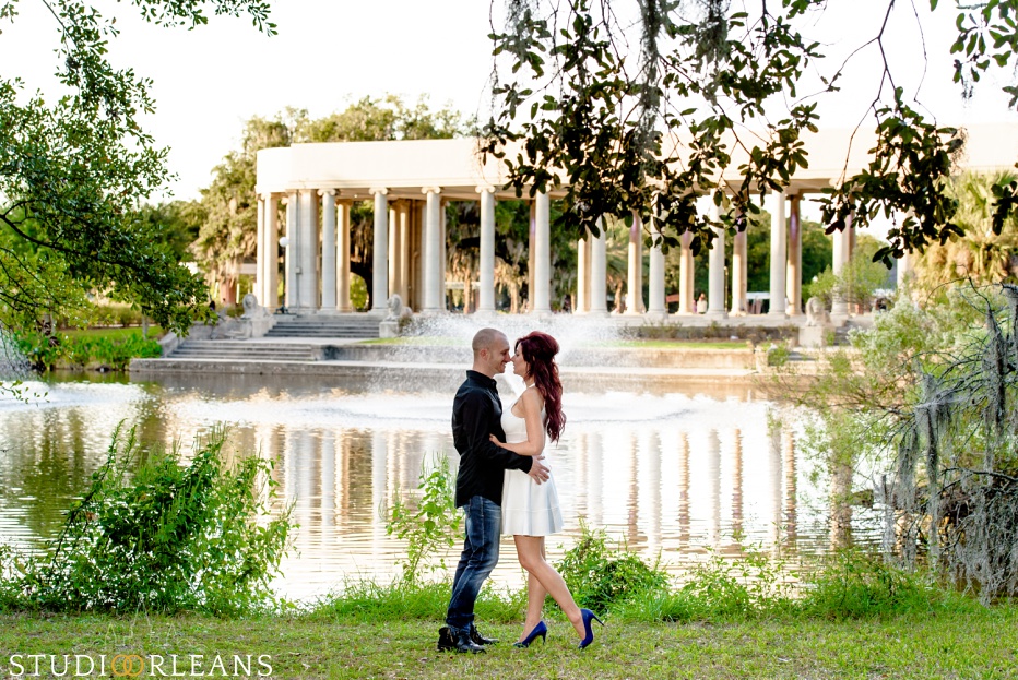 City Park Engagement Session in New Orleans with a couple standing under the amazing Oak trees