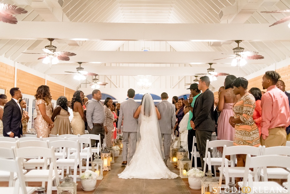 The bride gets escorted down the aisle. This was taken at Cedar Grove Plantation. Photo by Studio Orleans New Orleans Photographers