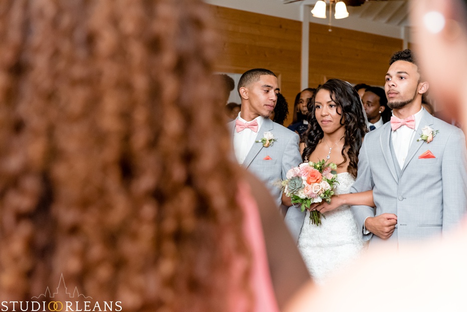 The bride gets escorted down the aisle. This was taken at Cedar Grove Plantation. Photo by Studio Orleans New Orleans Photographers