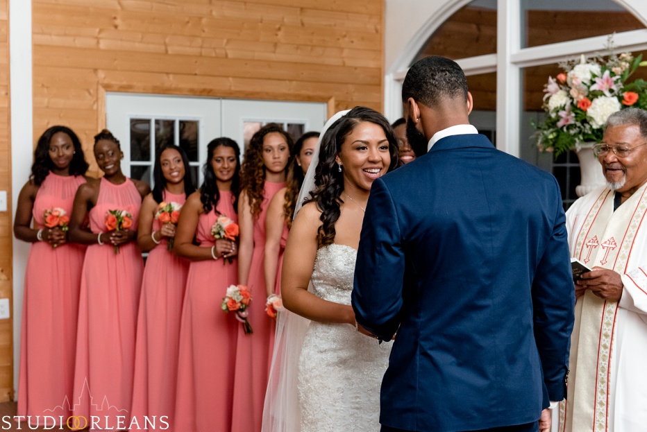 Checkout the way the bride looks at her groom and the bridesmaids watch. This was taken at Cedar Grove Plantation. Photo by Studio Orleans New Orleans Photographers