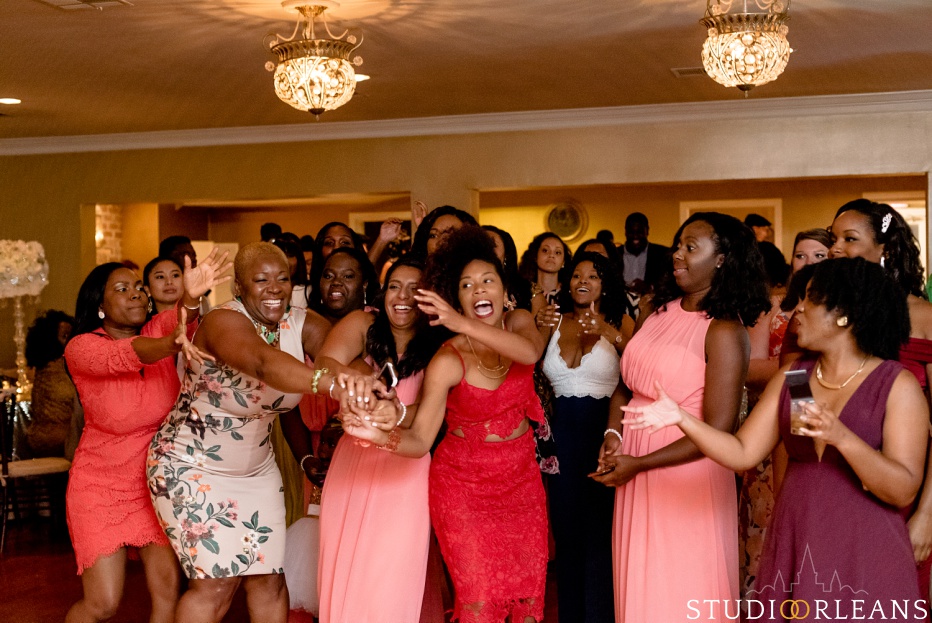 The bride throws her bouquet at Cedar Grove Plantation. Photo by Studio Orleans New Orleans Photographers
