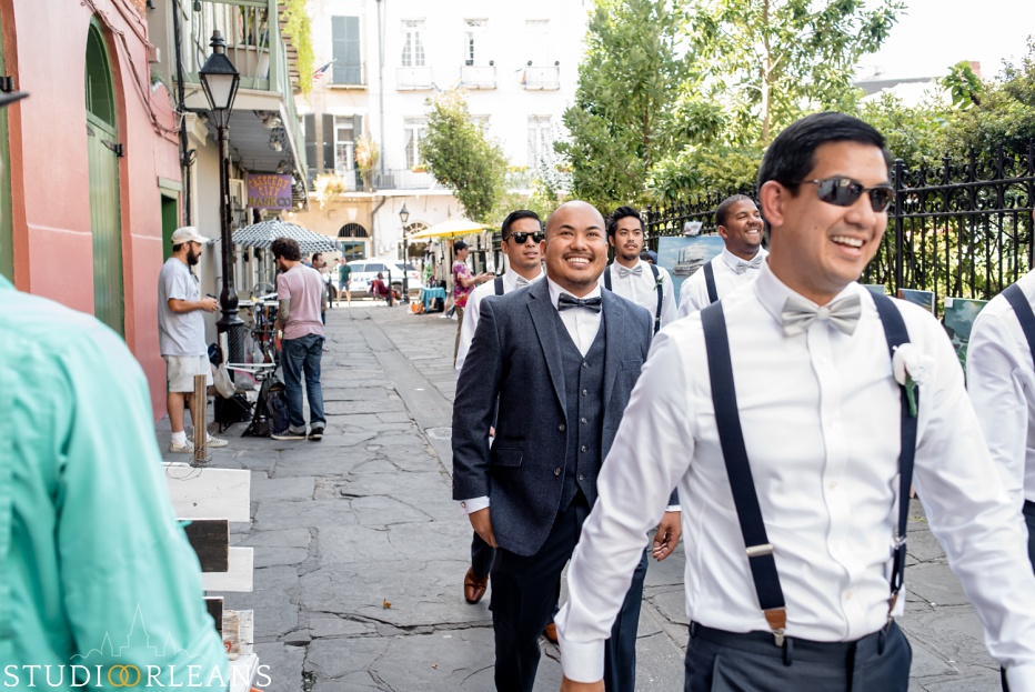 Groom walking to the Saint Louis Cathedral for his wedding in New Orleans