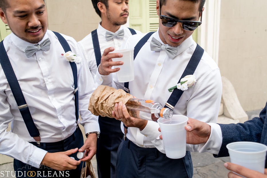 Groom and groomsmen getting ready for the wedding ceremony at the Saint Louis Cathedral in New Orleans