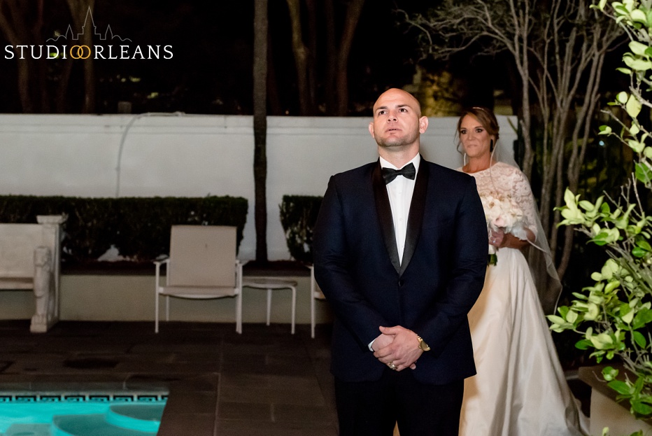 A groom waits for his bride for the "first look" in a New Orleans courtyard