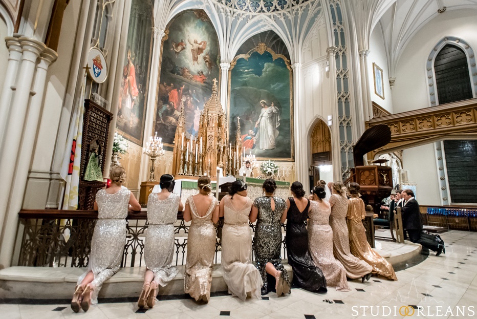 All of the bridesmaids kneel at the alter of Saint Patricks church in New Orleans