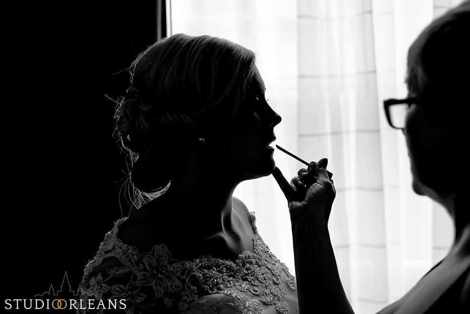 Chateau Lemoyne Wedding - Bride touching up lipstick before the ceremony