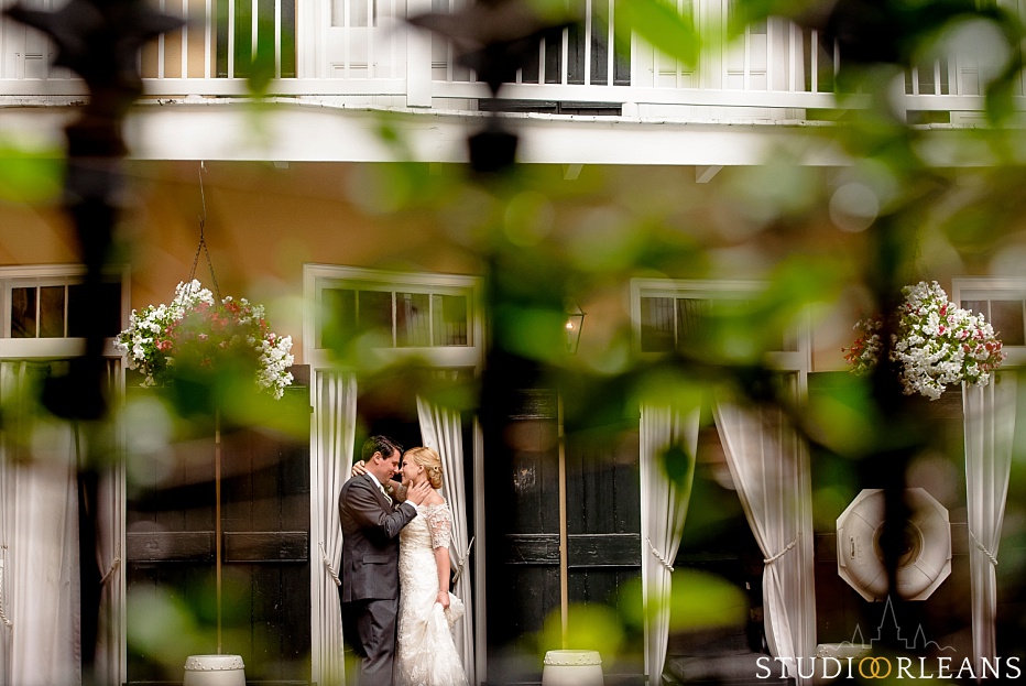 Bride and groom by the pool at the Chateau Lemoyne Hotel in the French Quarter of New Orleans