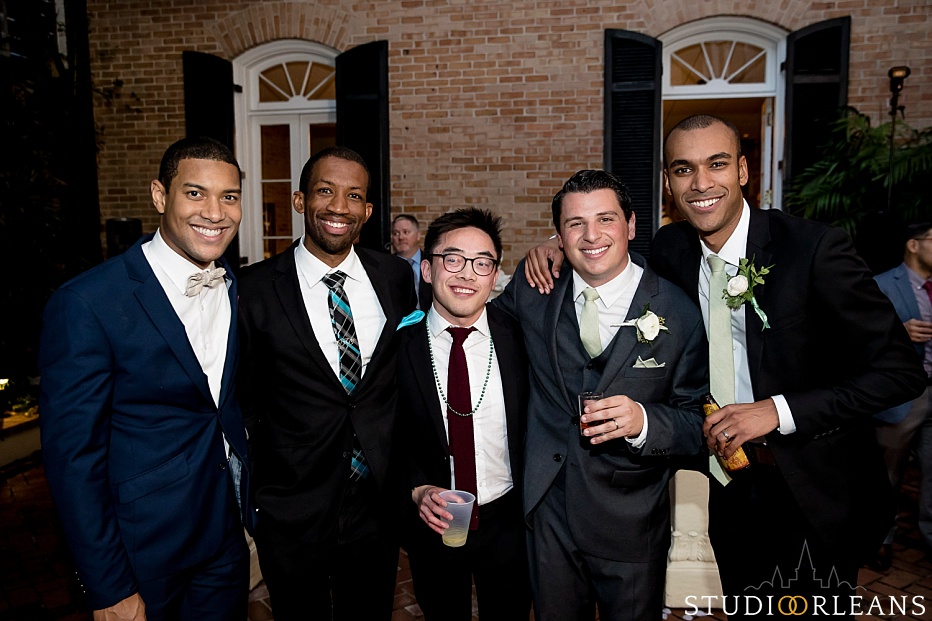 The groom with his college friends in the courtyard of Chateau Lemoyne hotel
