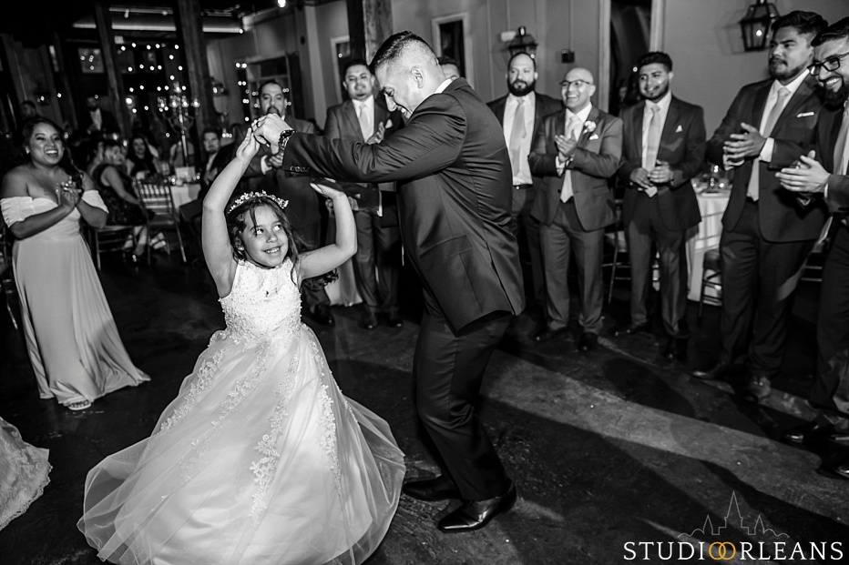 The groom dances with his daughter at the Chicory wedding venue in New Orleans