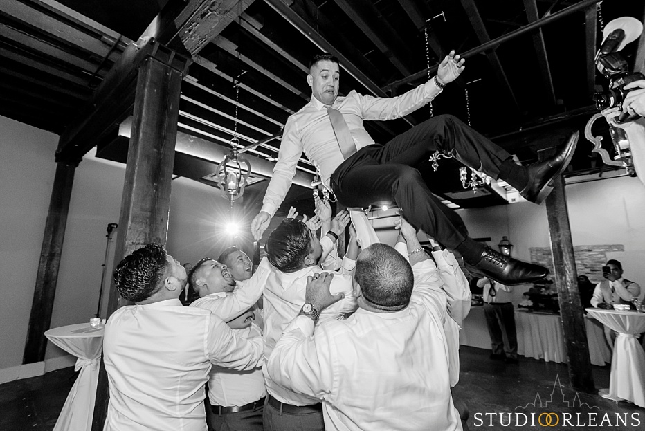 The groom gets thrown in the air at the Chicory wedding venue in New Orleans
