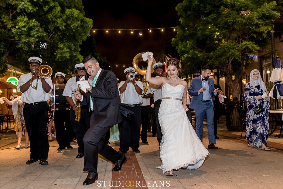 The married couple dances to a second line on Fulton Alley in New Orleans