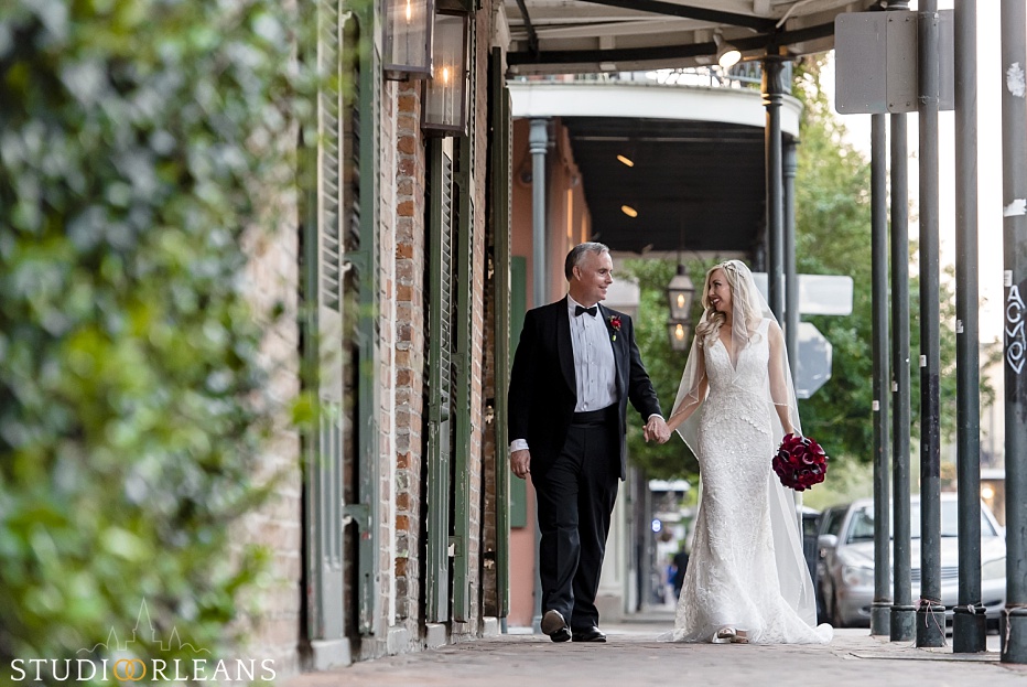 Bride and groom walking in the French Quarter after there beautiful elopement in New Orleans