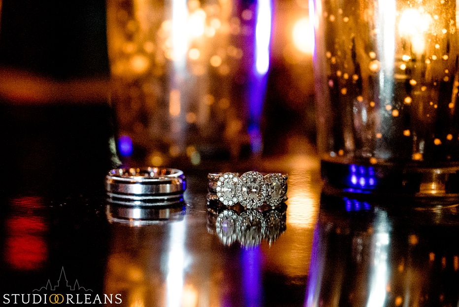 House of Blues Wedding - wedding rings on a table with pretty lights in the background