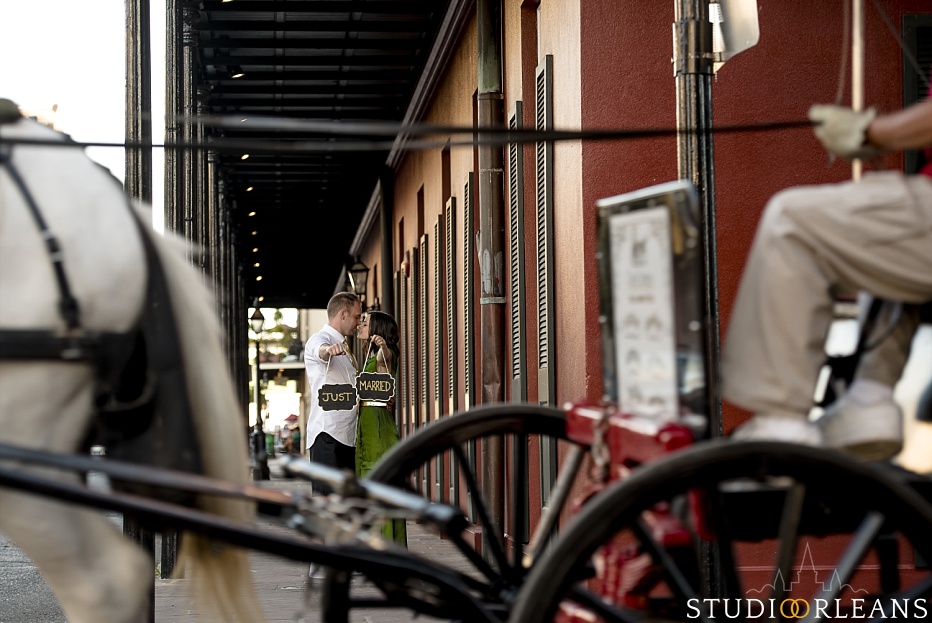 New Orleans Engagement Session in the French Quarter with the bride and groom holding up Just married sign