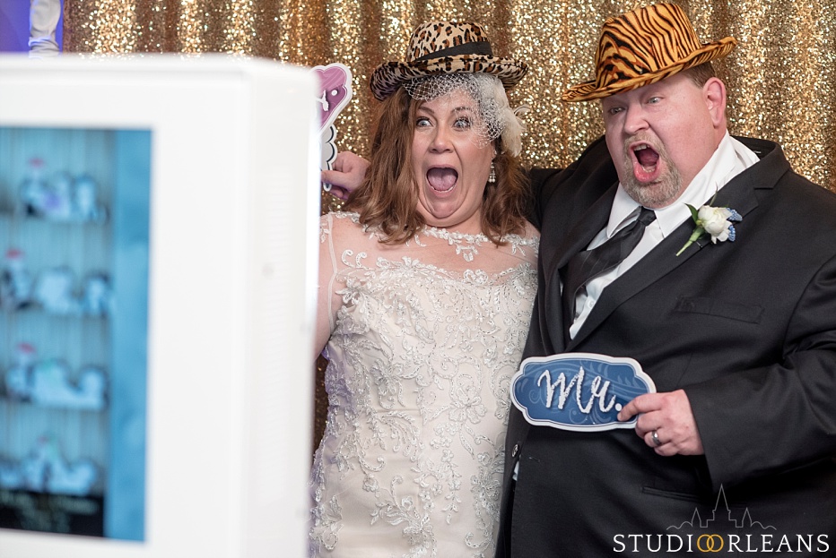 Pat O Briens on the river wedding reception bride and groom acting silly in the photobooth