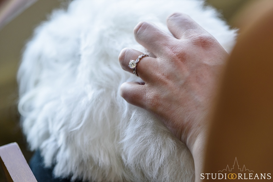 The bride pets her dog "Burney" while she waits to put her dress on