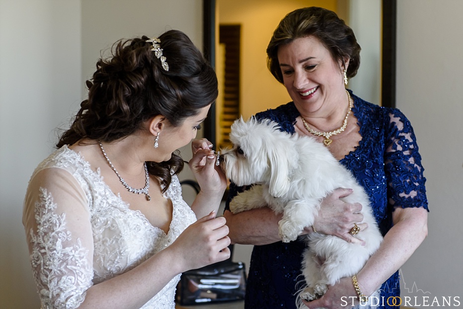 A mom, her daughter and her dog laugh and share a moment before her wedding 