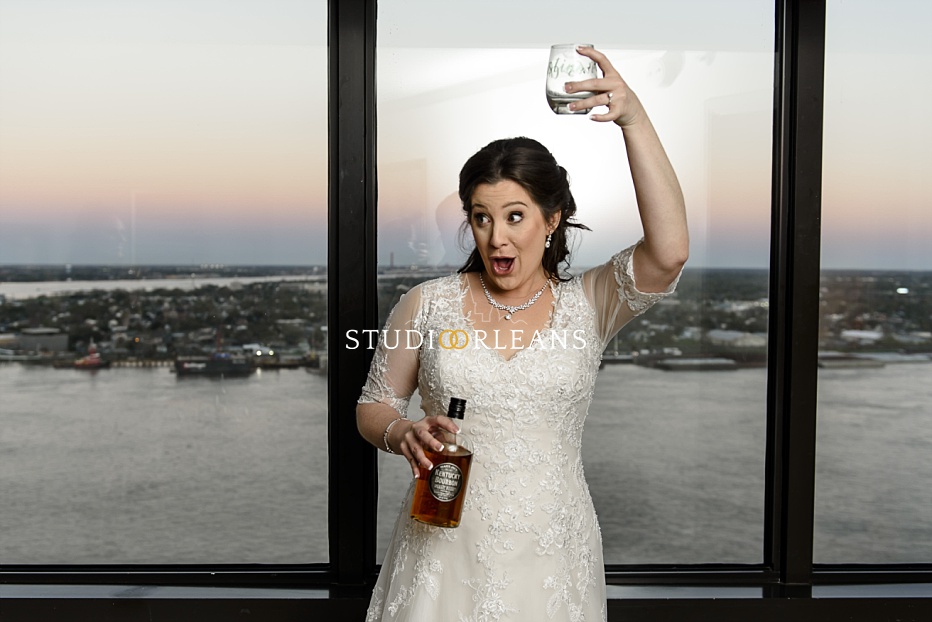 Whiskey anyone? The bride downed a shot of whiskey to calm her nerves. Checkout the Mississippi Riber in the background. New Orleans provides an excellent backdrop