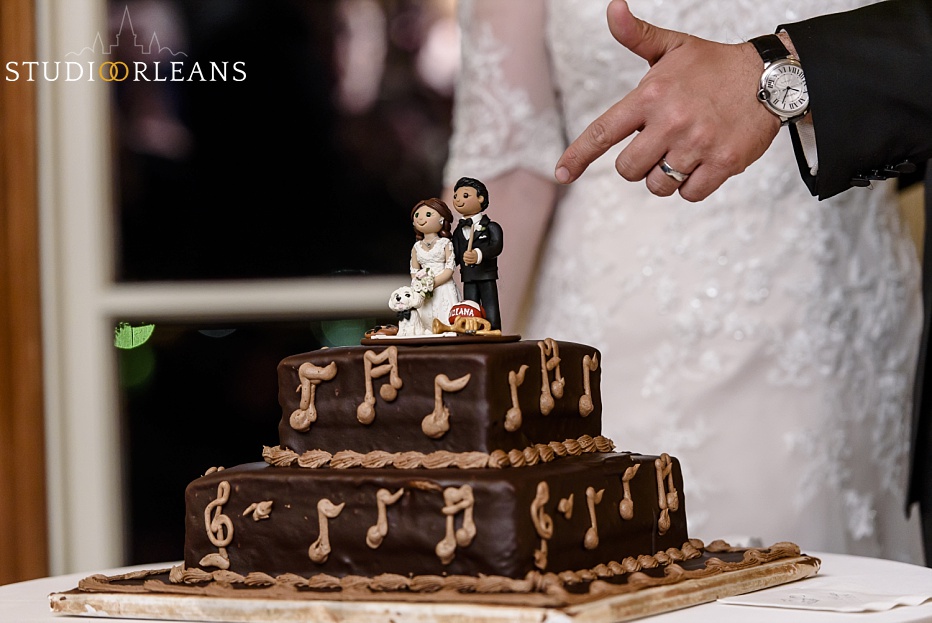 The bride and groom cut the grooms cake that was created by the Swiss Confectionery