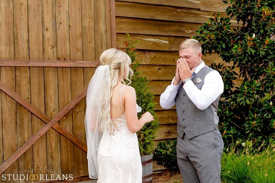 The groom sees his bride for the first look at The Berry Barn