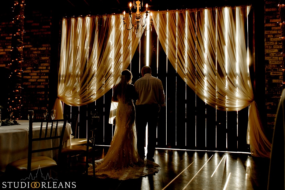 A bride and her father get ready to walk out of the Berry Barn for the wedding ceremony