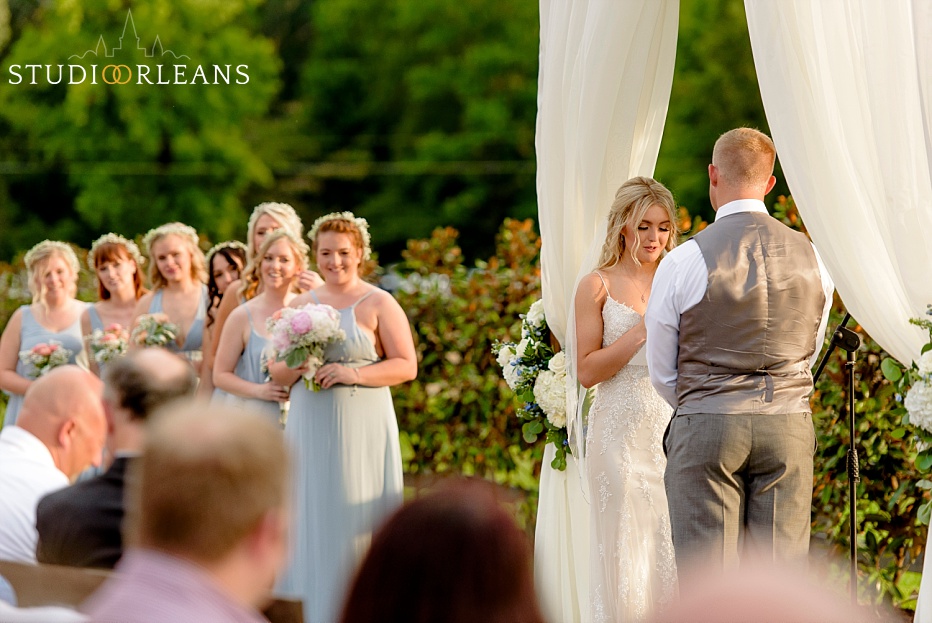 The bride says her wedding vows at the beautiful wedding ceremony at the Berry Barn
