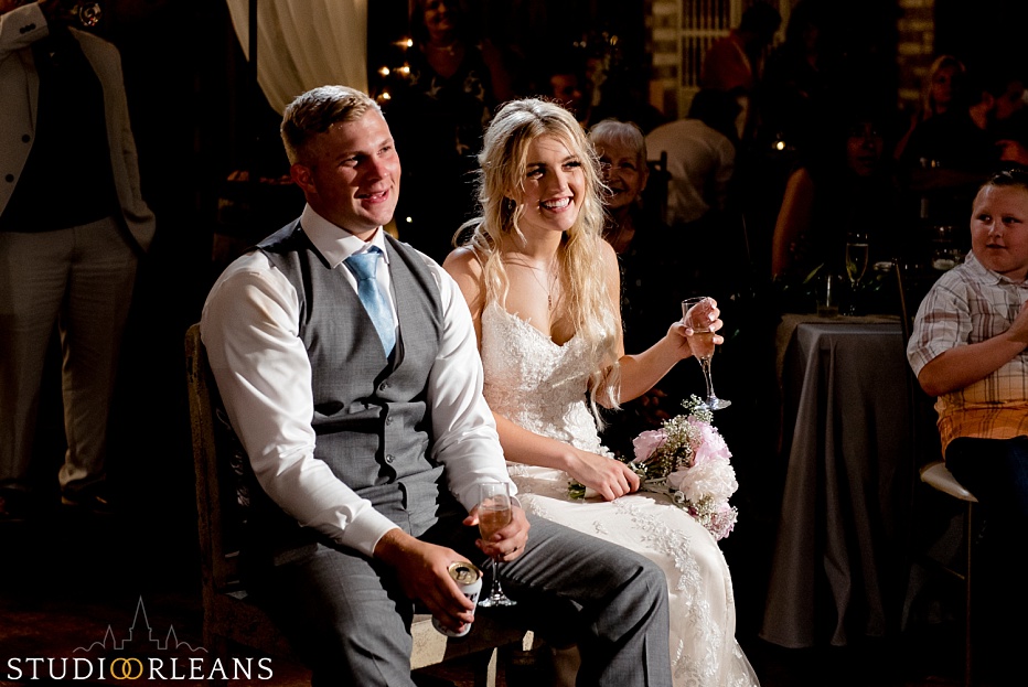 The couple laughs at the speech the groomsmen gives at the Berry Barn