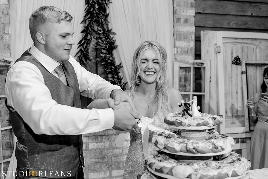 The couple cuts the wedding cake at the Berry Barn
