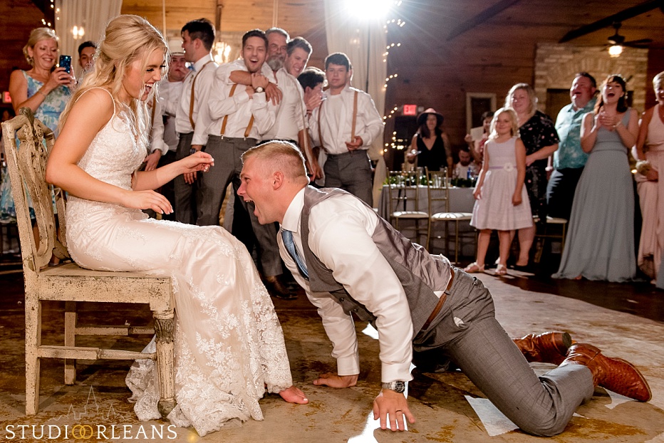 The groom dives in for the garter at the Berry Barn