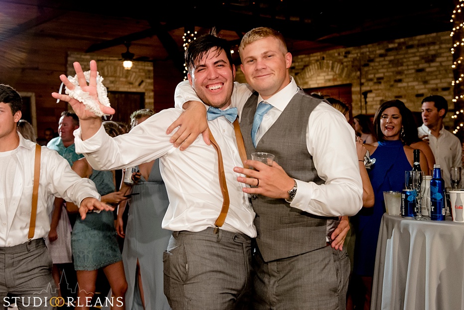 A groomsmen catches the garter at the Berry Barn